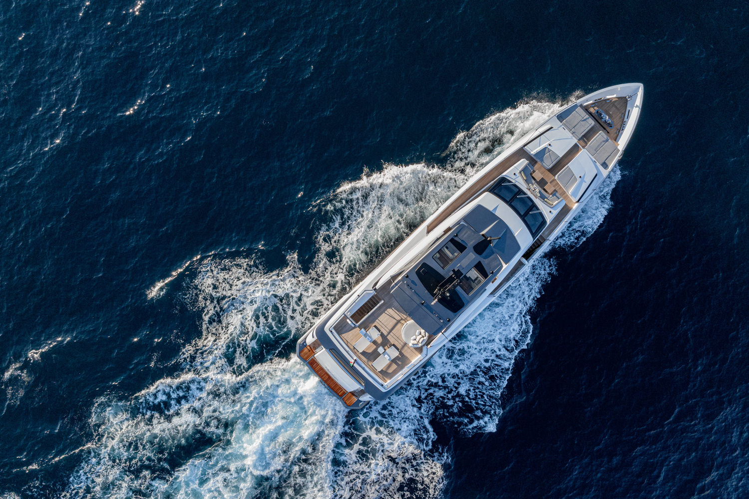 Aerial view of a luxury yacht cruising near Monaco captured by a professional drone photographer.