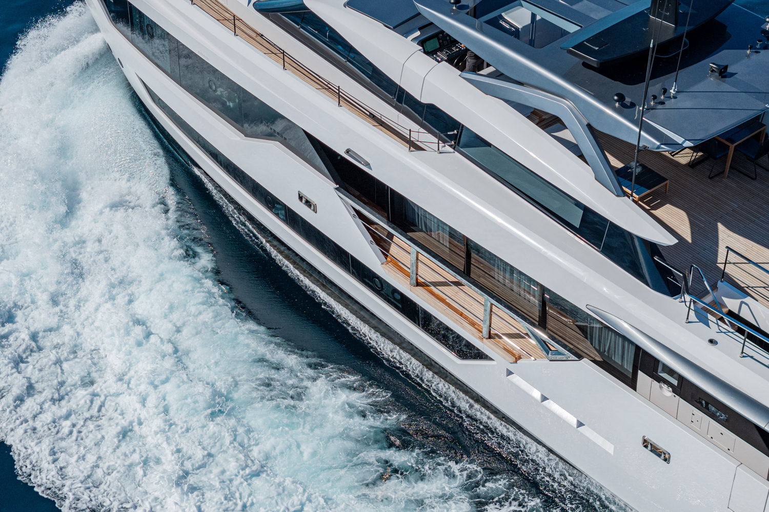Aerial photograph of a yacht cruising near Nice, with the stunning Mediterranean coastline in the background.