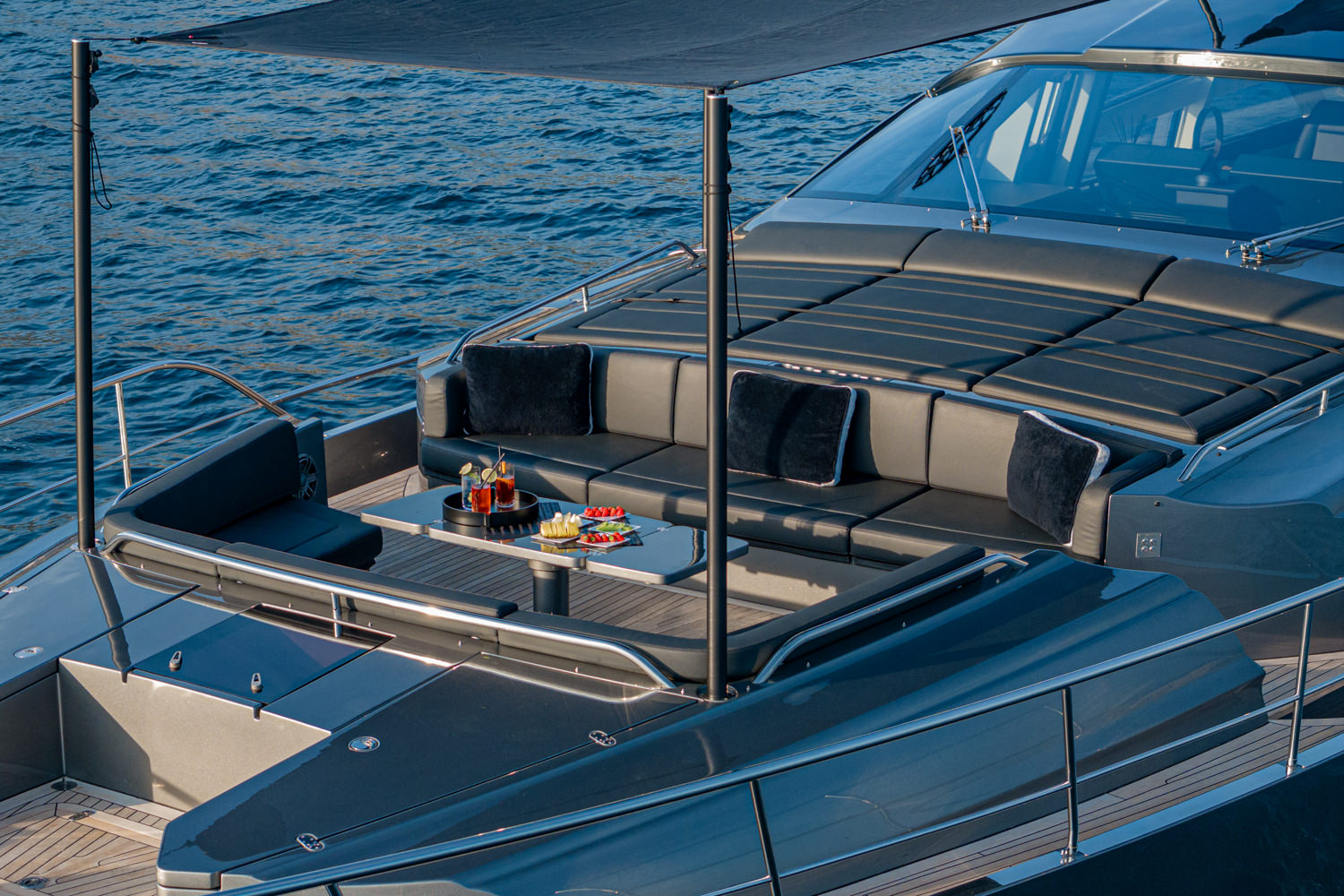 Aerial view of a yacht cruising near Antibes, with the Mediterranean Sea and coastline in the background.