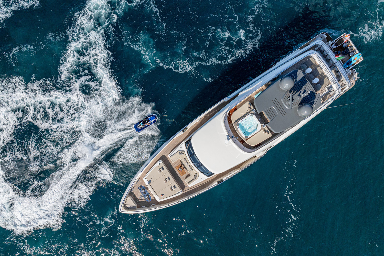 Aerial view of a yacht cruising along the Mediterranean coast near Monaco.