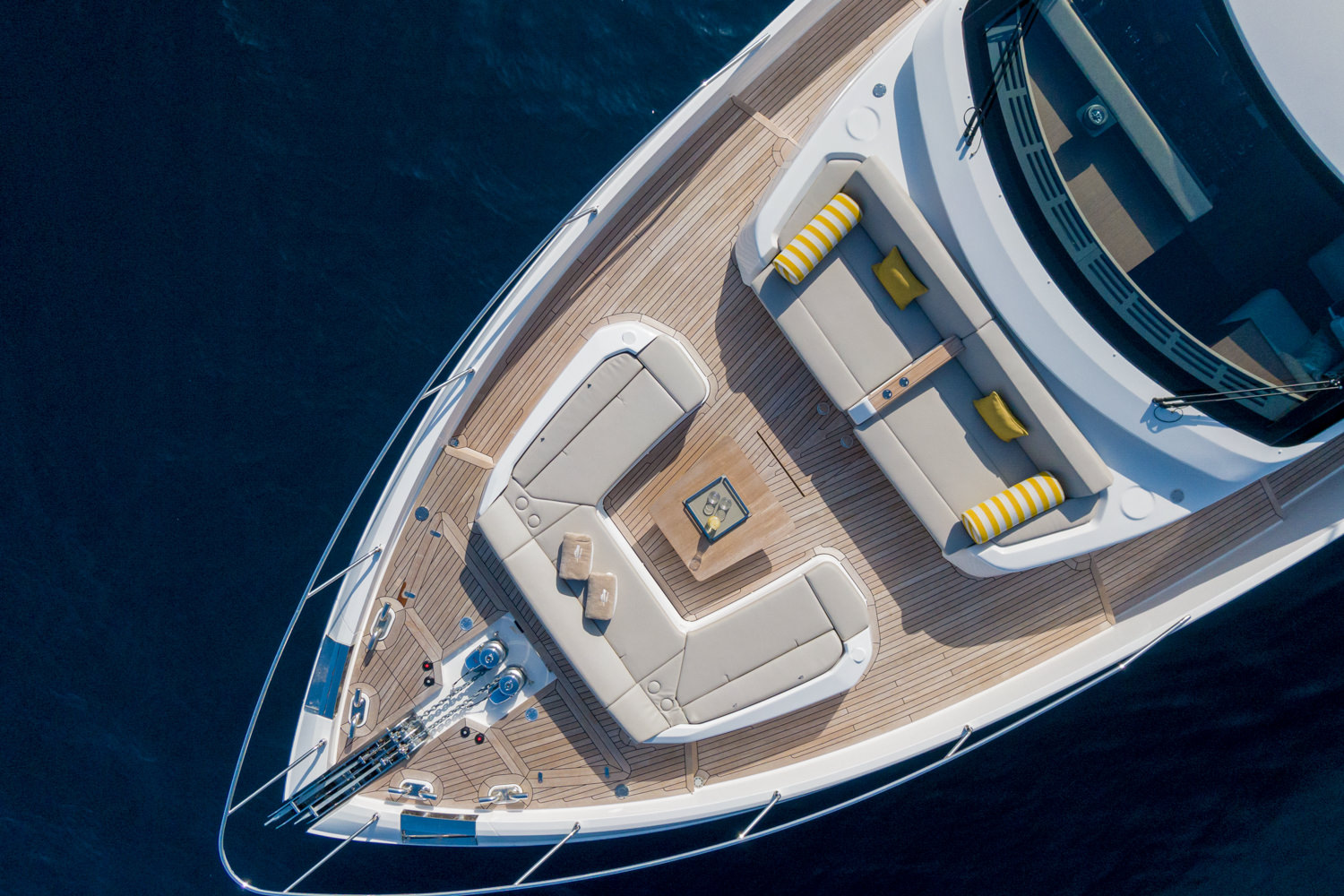 A luxurious yacht cruising the Mediterranean Sea, surrounded by crystal-clear waters.