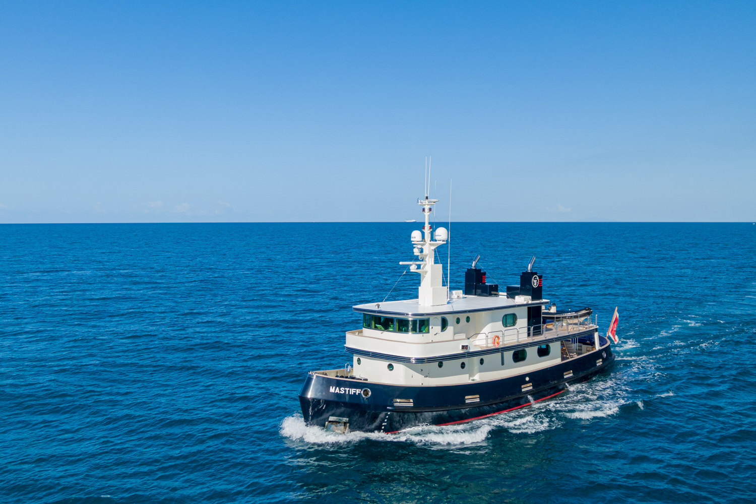 A luxurious yacht cruising the Mediterranean Sea, captured from above.