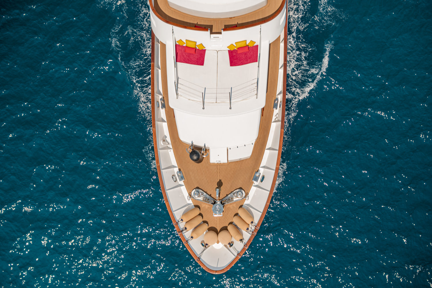 Aerial photograph of a luxury yacht sailing near Ventimiglia, with the Italian coastline in the background.