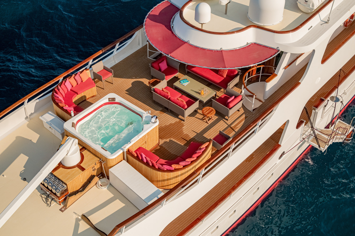 Drone view of a luxury yacht cruising near La Spezia, with the Ligurian coast in the background.