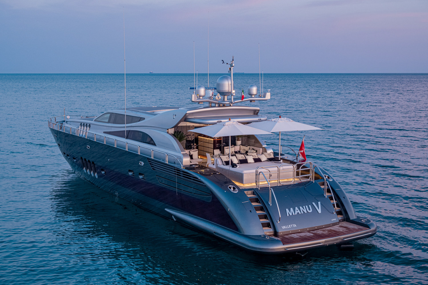 Aerial view of a luxury yacht sailing near Civitavecchia, with the coastline in the background.