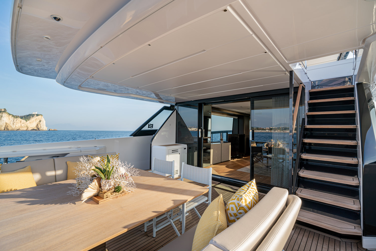 Luxury yacht deck at sunset in Monaco with elegant dining setup