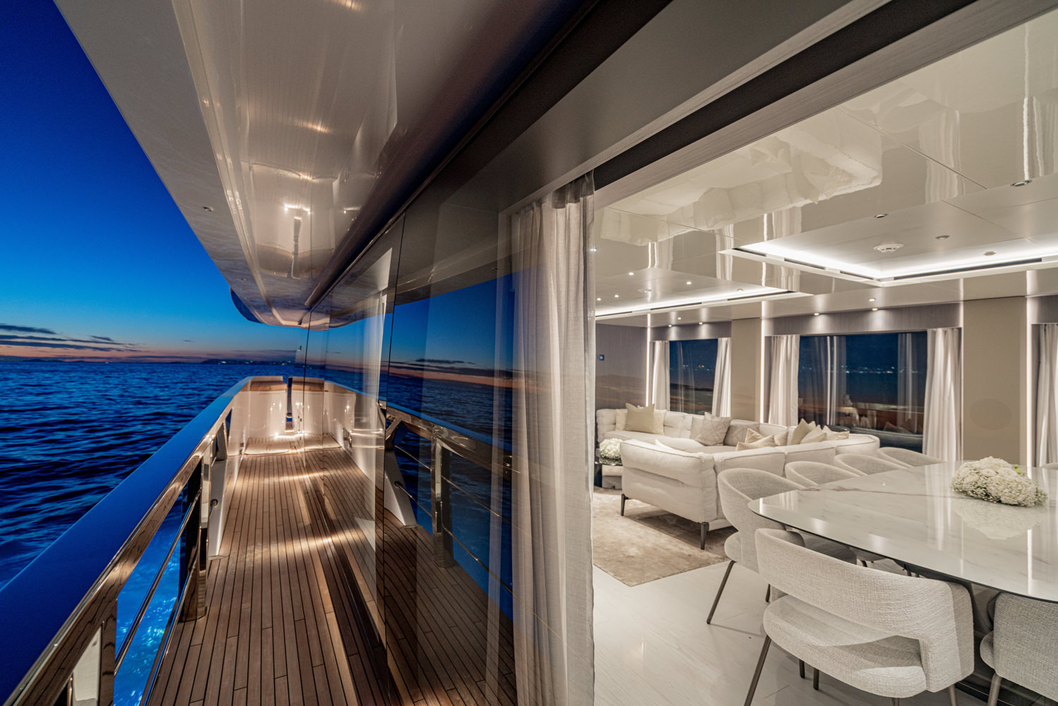 Elegant exterior of a luxury yacht with crystal-clear waters and a stunning coastline, captured during a yacht photoshoot in Cannes