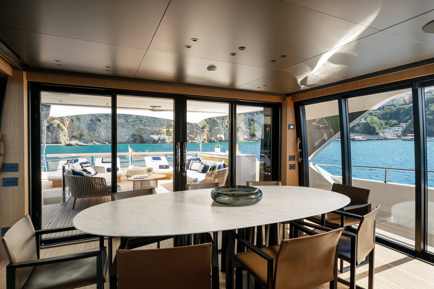 Upper salon of a Sanlorenzo yacht with elegant design, photographed in Cannes.