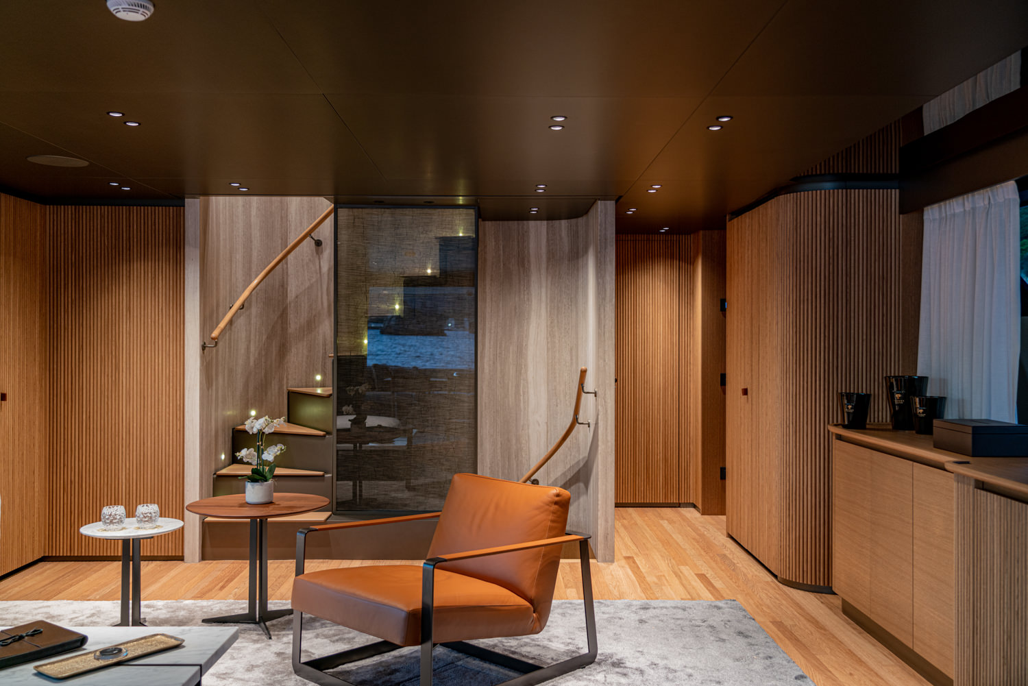 Elegant yacht salon with panoramic windows, photographed in Saint-Tropez.