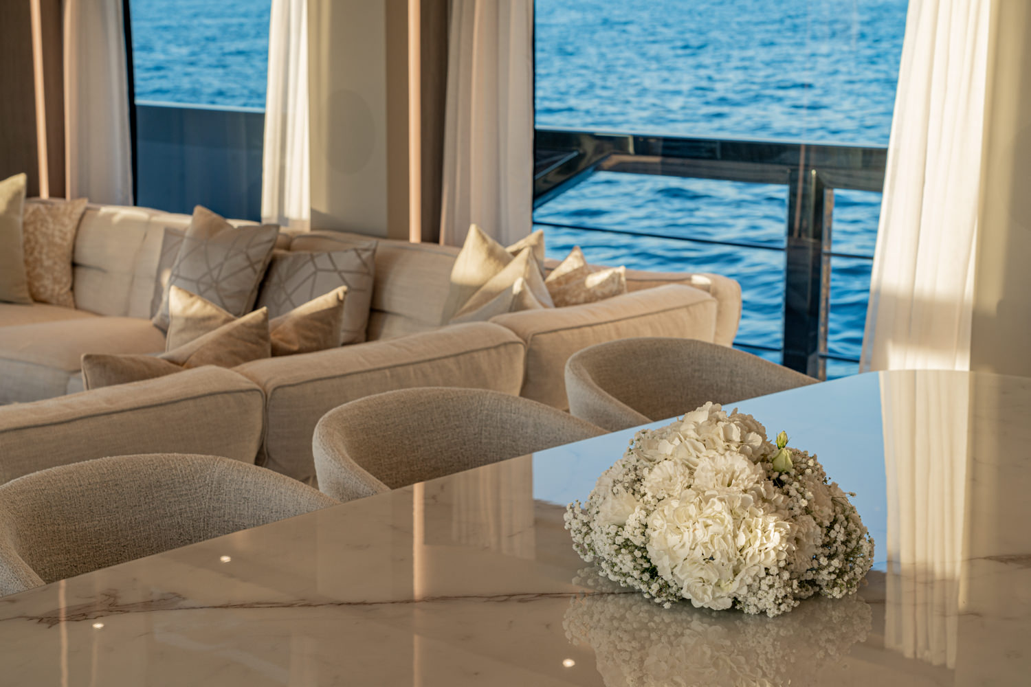 Close-up of a luxury dining table aboard a Ferretti yacht, photographed in Monaco.