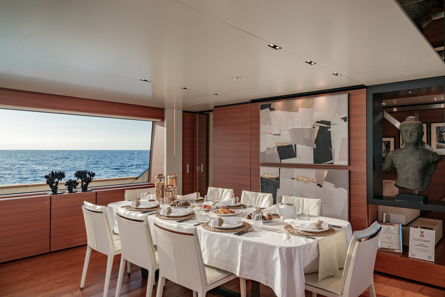 Elegant breakfast table set aboard a Ferretti yacht, photographed in Saint-Tropez.