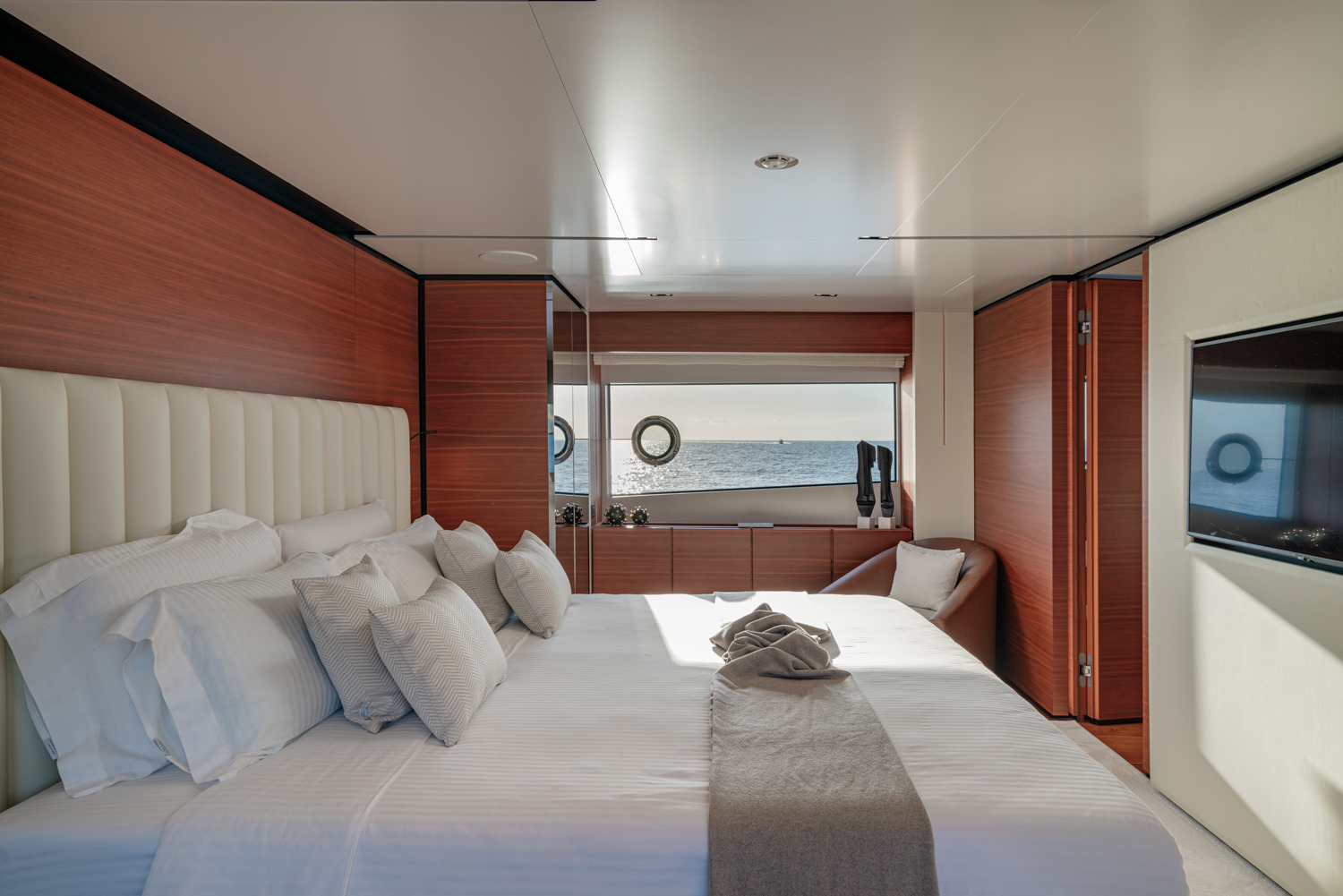Sophisticated master cabin aboard a Ferretti yacht, photographed in Monaco.