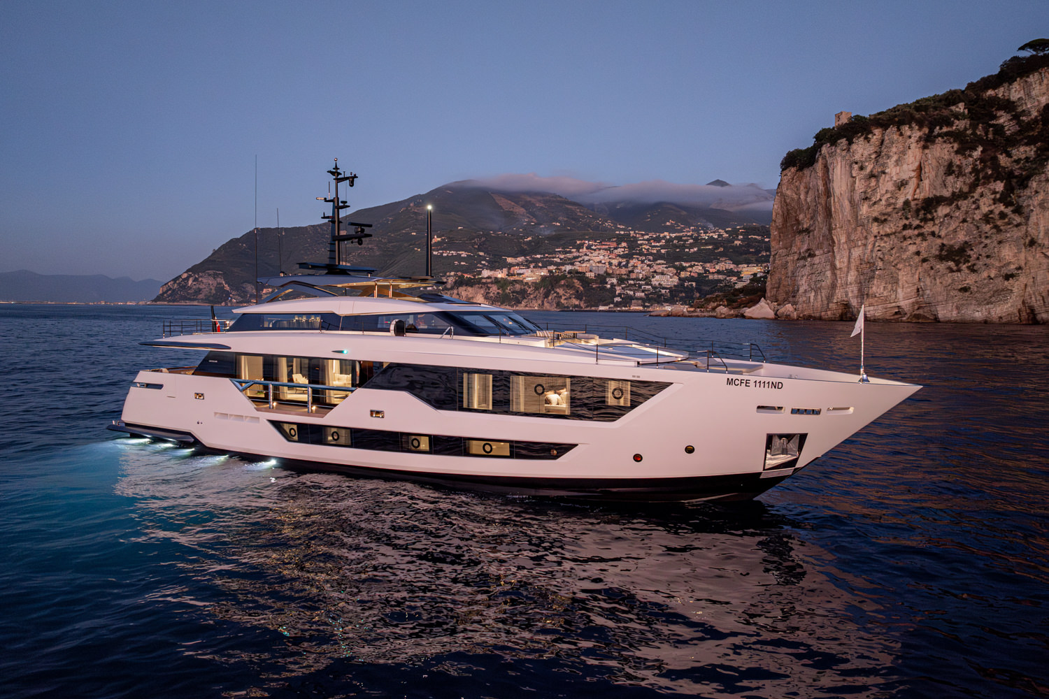 Drone view of a luxury yacht navigating near Ventimiglia, showcasing its sleek design.
