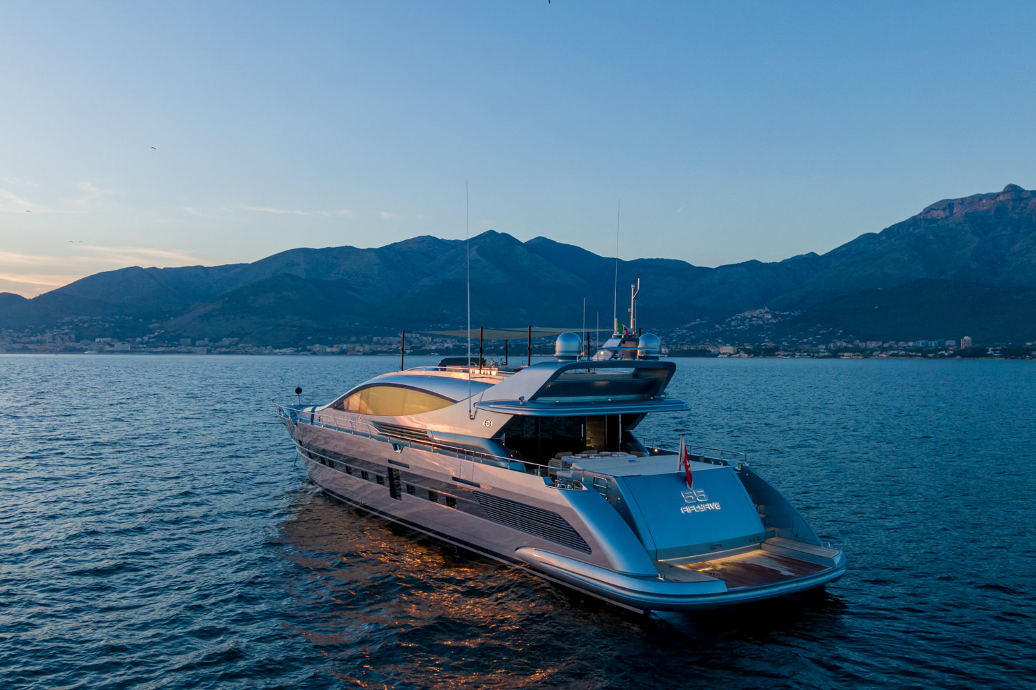 Drone-captured image of a luxury yacht anchored near Saint-Tropez, highlighting its elegant design.