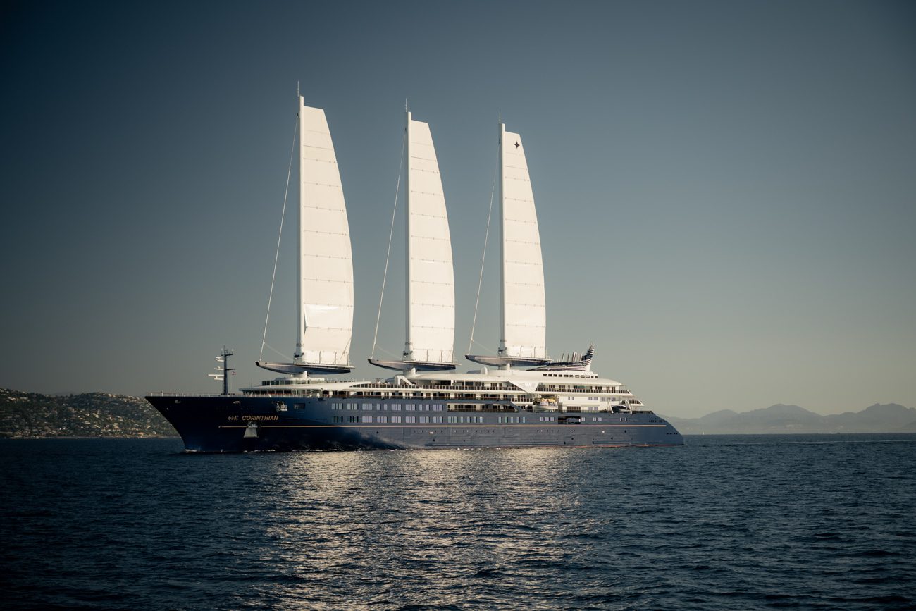 Grand voilier de luxe à trois mâts naviguant en mer, voiles déployées.