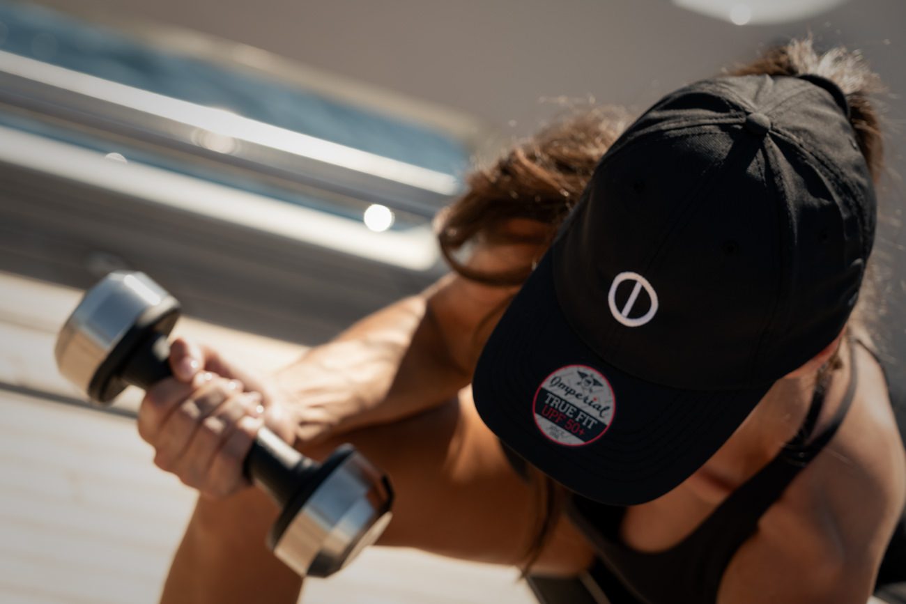 Close-up of a person's feet on water sports equipment on the deck of a yacht.